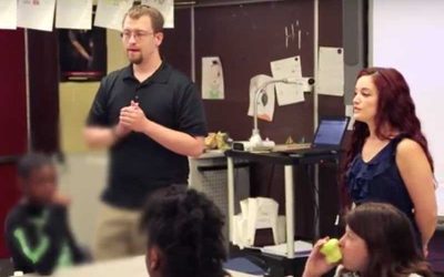 Two teachers speak to classroom