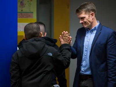 Teacher gives student high-five
