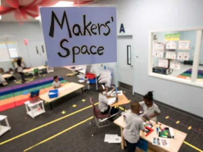 Photo of classroom and students with closeup of sign "Maker Space"
