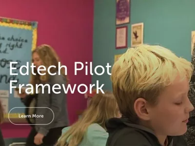 Screenshot showing a close-up of a child's face in a classroom with a teacher in the background that reads "Edtech Pilot Framework"
