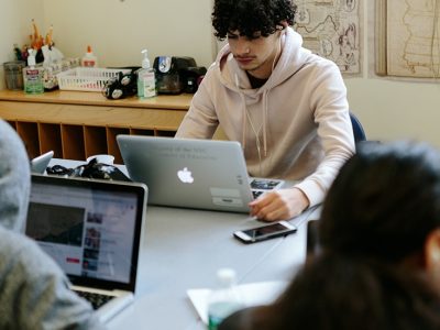 Students work individually on laptops
