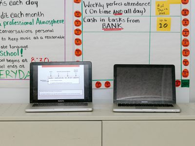 Two laptops set beside each other on a table
