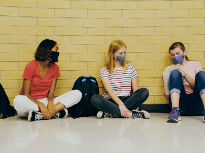 Students in hallway in a discussion
