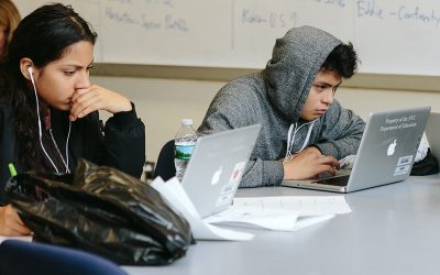 Two students working on laptops
