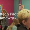 Screenshot showing a close-up of a child's face in a classroom with a teacher in the background that reads "Edtech Pilot Framework"